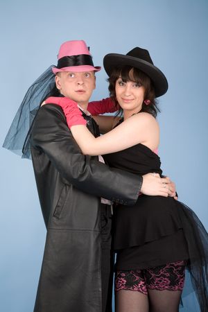 Woman in black hat and dress  and a man in pink hat