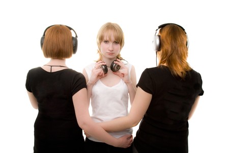 Redhead, blond and brunette girls standing in headphonesの写真素材