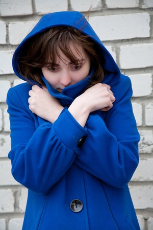 Homelessness woman standing near wallの写真素材