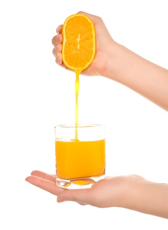 Woman's hands with orange fresh juiceの写真素材