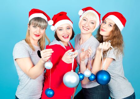 Four happy women with new year balls smilingの写真素材