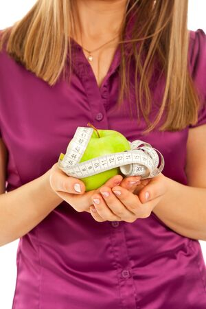 Woman holding a green juicy appleの写真素材