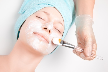 Young woman at spa procedures applying maskの写真素材
