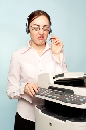 Angry businesswoman with copier thinking on the  background