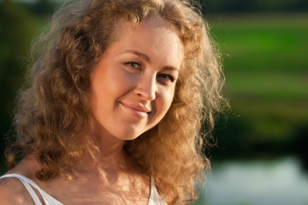 Portrait of beautiful miling woman outdoorsの写真素材
