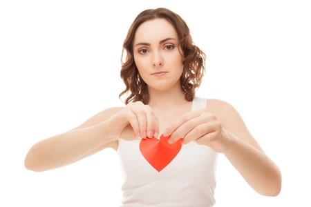 Attractive brunette young girl holding broken paper red valentine heartの写真素材