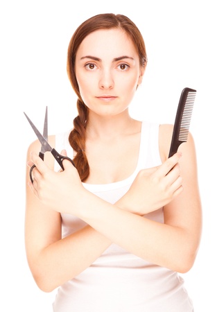 Hairdresser holding a  scissors and comb smiling isolated on whiteの写真素材