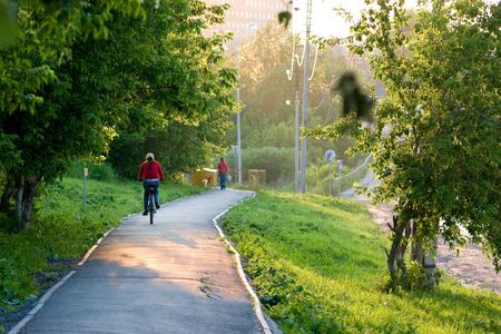 Girl riding a bicycle at summer streetの写真素材