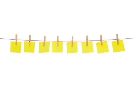 Eight yellow stickies hanged on red rope isolated on whiteの写真素材