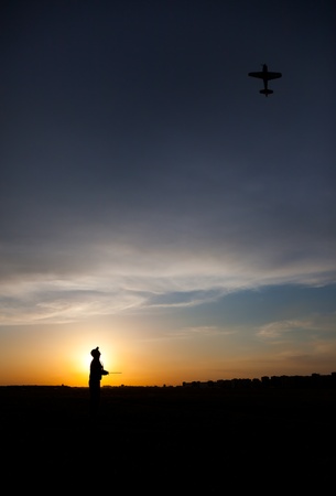 Man silhouette with rc plane (focus on RC model)の写真素材