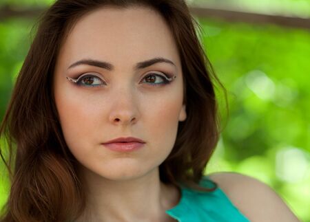 Portrait of woman with creative bridal makeup outdoorsの写真素材