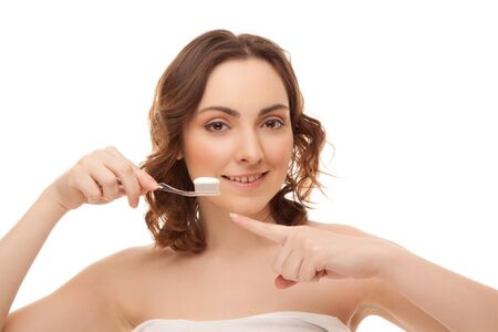 Woman with toothbrush isolated on whiteの写真素材