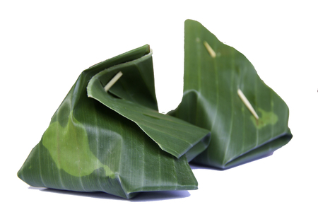 Thai dessert, Sticky rice with steamed custard, wrapped in banana leaves.の写真素材