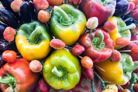 Yellow, green and red colorful bell peppers, natural backgroundの写真素材