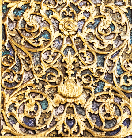 Ancient golden carving wooden window of Thai temple. Thailand