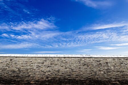 Thai style art on the roof in temple, blue sky, Thailand