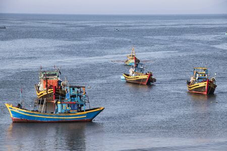 Mui Ne, Vietnam - Feb 23, 2017. Fishing boats docking on the sea in Binh Thuan, Vietnam. Binh Thuan Province is known for its beaches and coastal roads.のeditorial素材