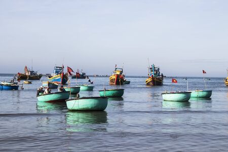 Mui Ne, Vietnam - Feb 23, 2017. Fishing boats docking on the sea in Binh Thuan, Vietnam. Binh Thuan Province is known for its beaches and coastal roads.のeditorial素材