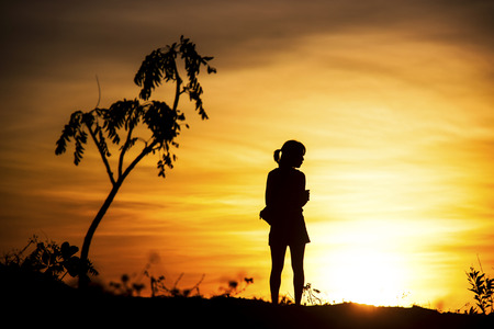 women stand on the background of sunset skyのeditorial素材