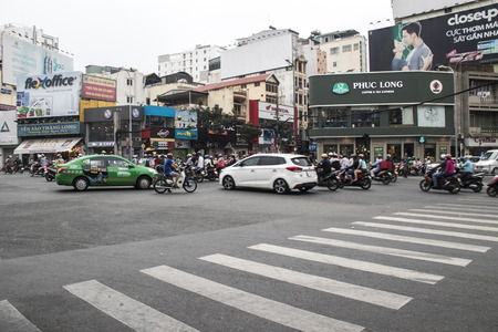 HOCHIMINH CITY, VIETNAM - Feb 24, 2017: Amazing traffic of Asia city, group citizen on privaet vehicle in rush hour, mob of people in helmets, riding motorcycles in Vietnam, February 24, 2017のeditorial素材