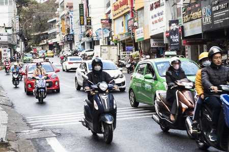 HOCHIMINH CITY, VIETNAM - February 24, 2017: Amazing traffic of Asia city, group citizen on privaet vehicle in rush hour, mob of people in helmets, riding motorcycles in Vietnam, February 24, 2017のeditorial素材