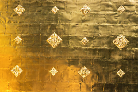 Shiny yellow leaf gold foil texture backgroundの写真素材