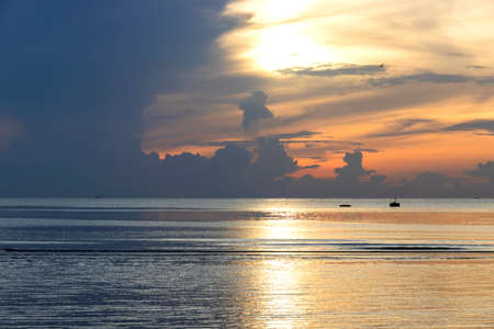Sunset sky and clouds over the sea backgroundsの写真素材