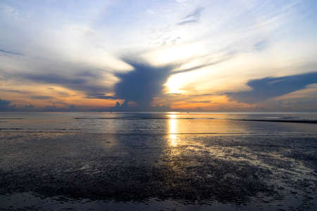Sunset sky and clouds over the sea backgroundsの写真素材