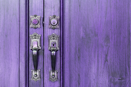 Old wooden door with steel door handlesの写真素材