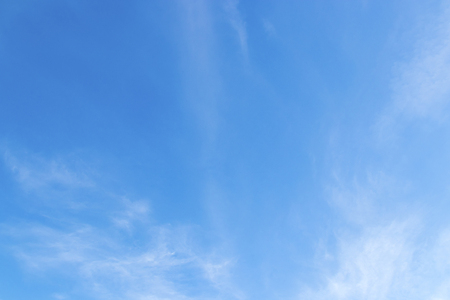 Blue sky background with cloudsの写真素材