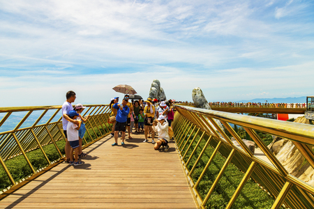 Danang, Vietnam - June 24, 2019: The Golden Bridge is lifted by two giant hands in the tourist resort on Ba Na Hill in Danang, Vietnam.のeditorial素材