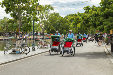 Hoian, Vietnam - JUNE 25, 2019 : Taxi tricycle park in Hoi an old town service tourists by bike around old town .のeditorial素材