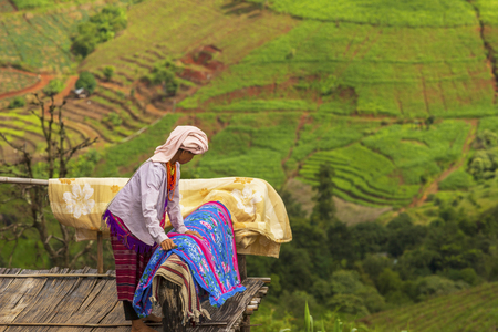 Chiang Mai , Thailand , August 11 , 2019 :Karen woman Clean the house on the top of the hill.のeditorial素材