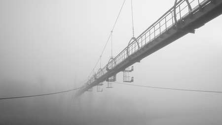 Bridge over the river into fogの写真素材