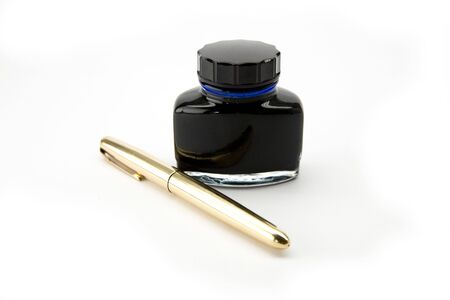 Ink well and gold penの写真素材