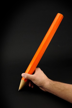 Big pencil in handの写真素材