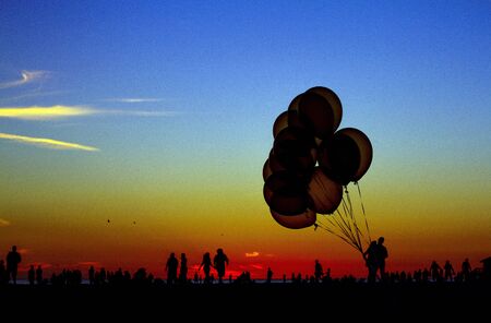 Balloon silhouette at the beach during sunsetの写真素材