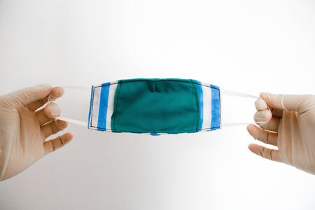 Hands holding a face mask