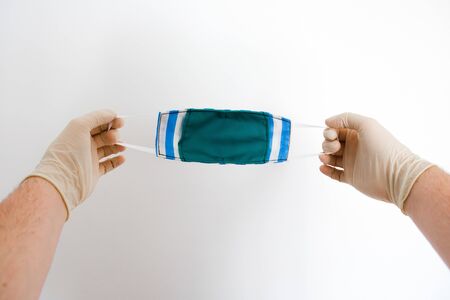 Hands holding a face mask