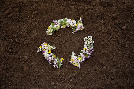 Flower recycling symbol on earth backgroundの写真素材