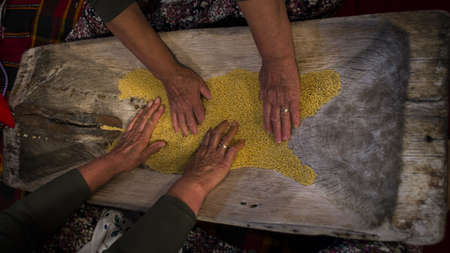 Village women on the wood are making couscousの写真素材