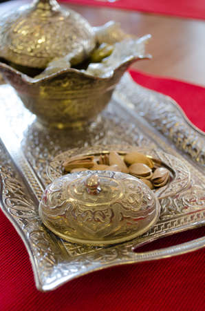 Pistachios, Pistachio nuts in wooden bowl on checkered clothの写真素材