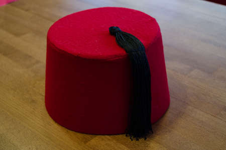 The ottoman hat on the wooden table