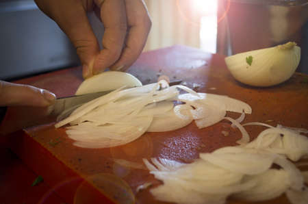 Man chopping onion on cutting boardの写真素材