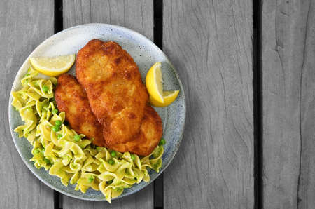 The most famous dish of austria: Chicken Schnitzel With Egg Noodlesの写真素材