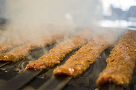 Kebabs cook in side barbecueの写真素材