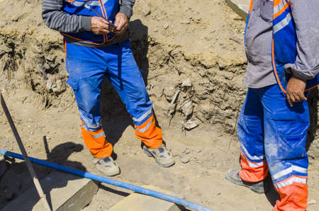 Construction workers renovating road