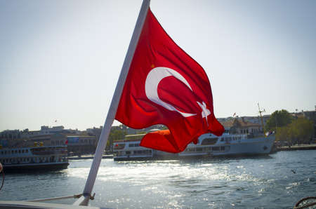 flag of turkey and lifebuoy on back of a boat in bosphorus strait istanbul turkeyの写真素材