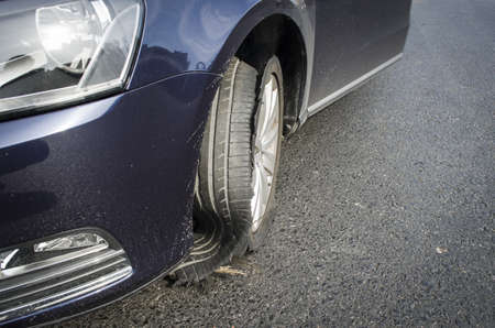 damaged tire after tire explosion at high speed on highwayの写真素材
