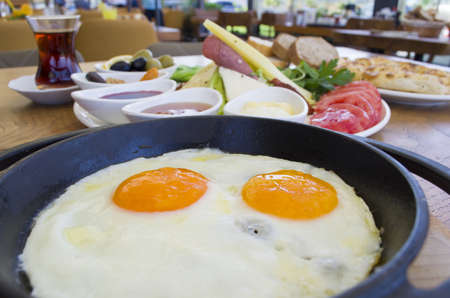 fried egg and tea on wooden tableの写真素材